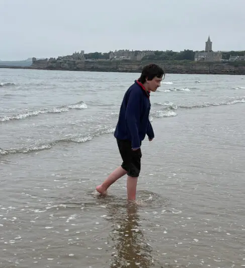 Young man paddling in North Sea